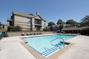 Overland Park apartment for rent - The pool area, features clear blue water and plenty of space to relax.